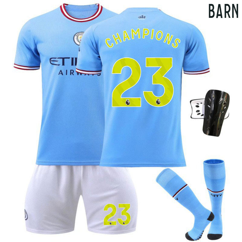 CHAMPIONS #23 Manchester City Hjemmedrakt 2022-23 Barn Kortermet + Korte bukser